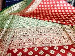 seller showing mysore silk saree prices to customer 